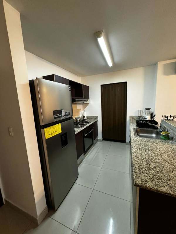 Open mezzanine bedroom overlooking living room in furnished PH Vitroloft Panama City