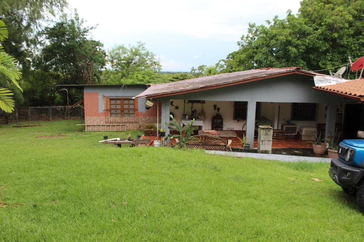 Aerial of country house with green lawn, swimming pool and mountain views in Cerro Azul Panama