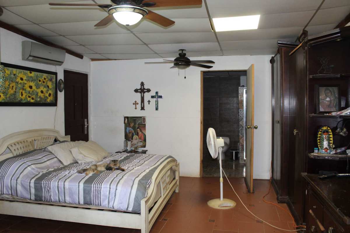 Spacious rustic living room with wood rail, split-level design in Cerro Azul Panama estate