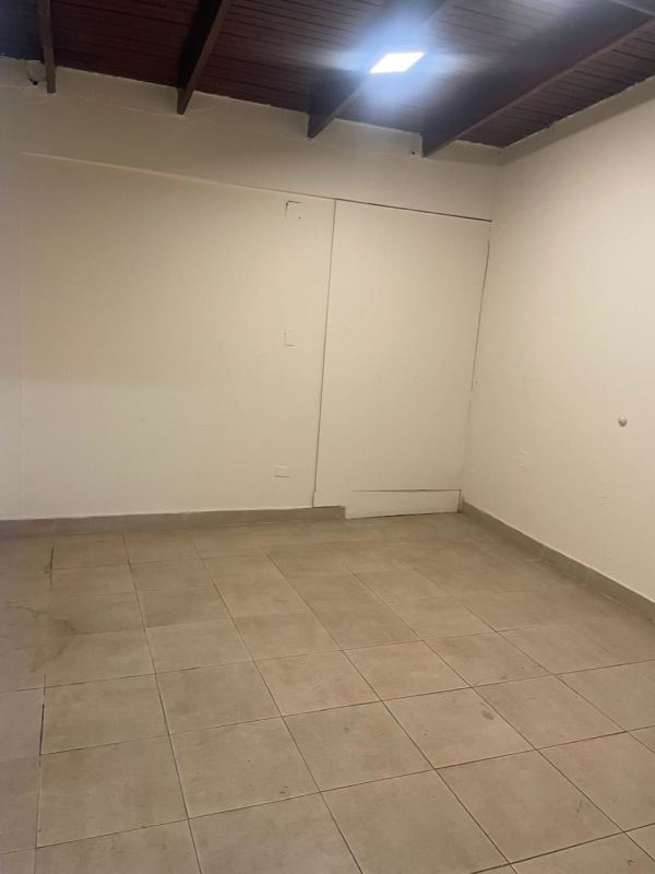 Empty retail or office space with tiled floor and exposed wooden ceiling Panama City