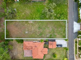 Outlined vacant lot with house and driveway within Coronado Golf & Beach Resort in Panama