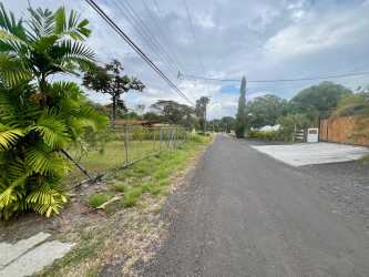 Street and utility access to grassy fenced land in Coronado Golf and Beach Resort Panama
