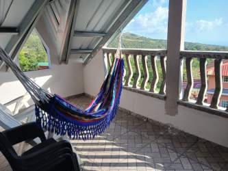Bright bedroom with blue decor, two large windows and tufted headboard Chicá Panama