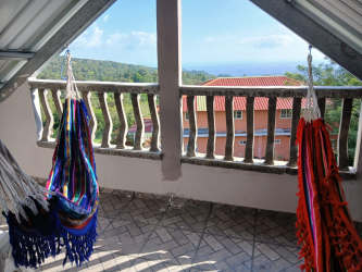 Contemporary kitchen with tiled walls, cabinets and blue walls mountain house Panama