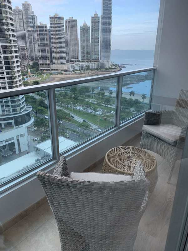Modern bathroom with granite countertop vanity and walk-in shower at PH Bayfront Tower Panama