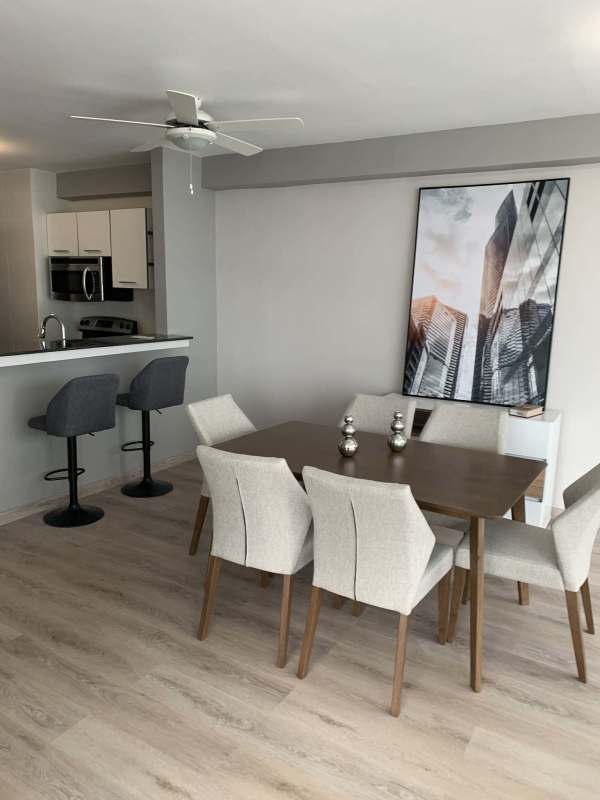 Elegant open concept kitchen with breakfast bar and dining near balcony PH Bayfront Tower Panama
