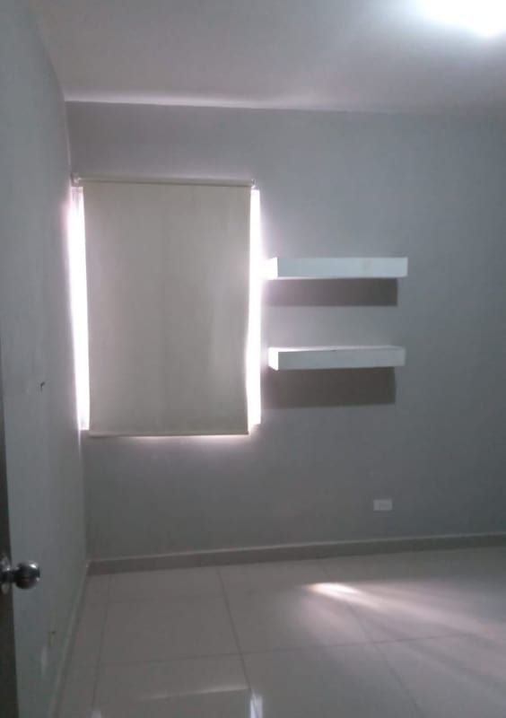 Minimalist townhouse bedroom with roller blind and floating shelves PH Azahares Panama City