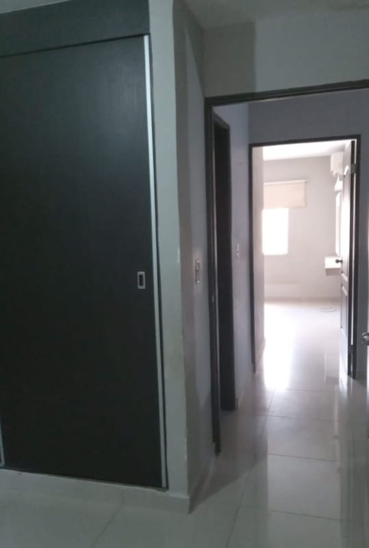 Townhouse hallway with built-in sliding closet doors in PH Azahares Pedregal Panama