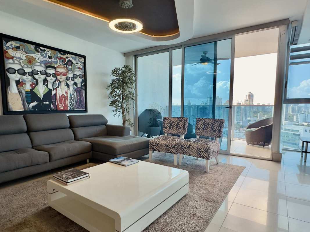 Furnished contemporary living room with floor-to-ceiling windows and balcony PH Waterfalls San Francisco Panama City