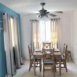 Aerial view of Playa Dorada beachfront community with pools, slides, mountain backdrop