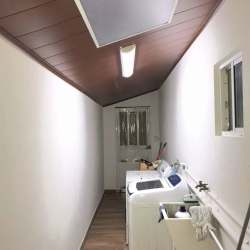 Laundry room featuring washer, dryer space, wood ceiling and window in PH Las Olas Playa Dorada