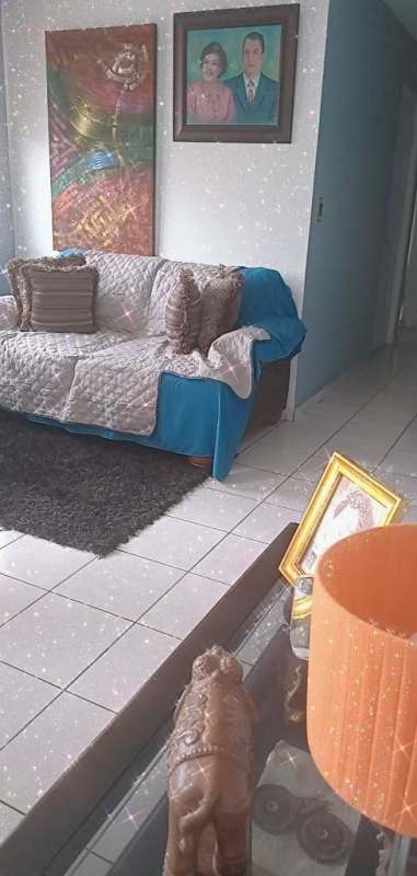 Laundry area with washing machine and storage shelves at PH Torres de Milán student apartment near UTP Panama