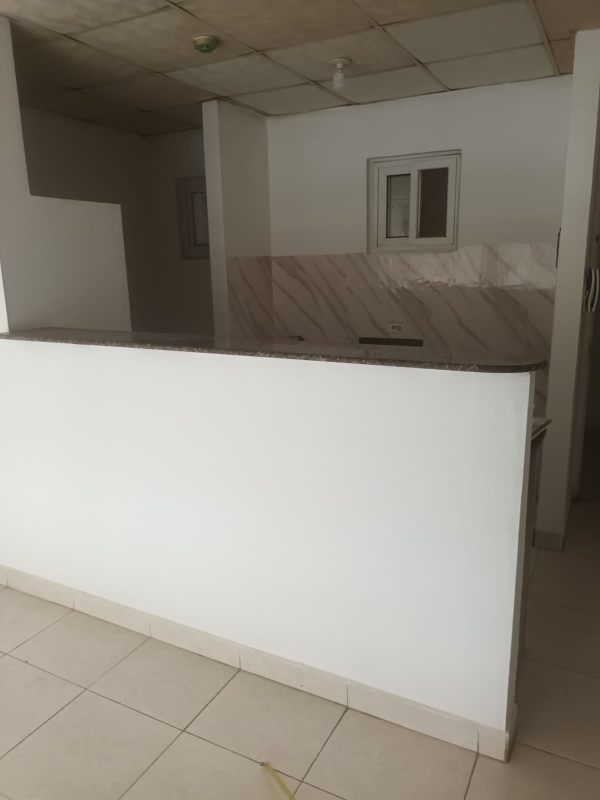 Empty bedroom with built-in closet and view of bathroom door in Pedregal apartment