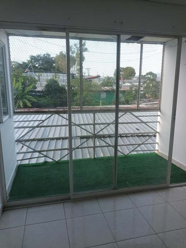 Small balcony enclosed with safety net and synthetic grass Pedregal rental Panama