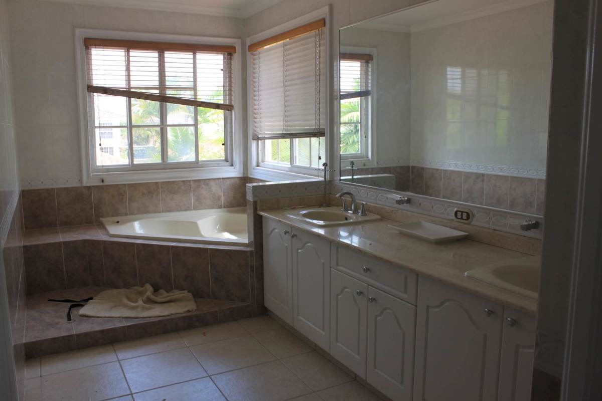 Spacious traditional kitchen with granite tops, island, white cabinets in Costa Azul Costa del Este house