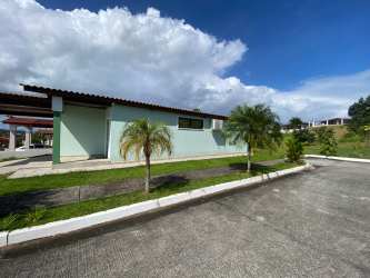 Single-story house with large windows, driveway, landscaping in Brisas del Golf Arraiján, Panama