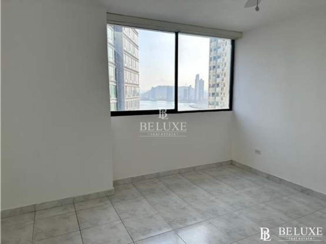 Equipped kitchen with white cabinets, tile backsplash, stove and fridge Punta Paitilla Panama