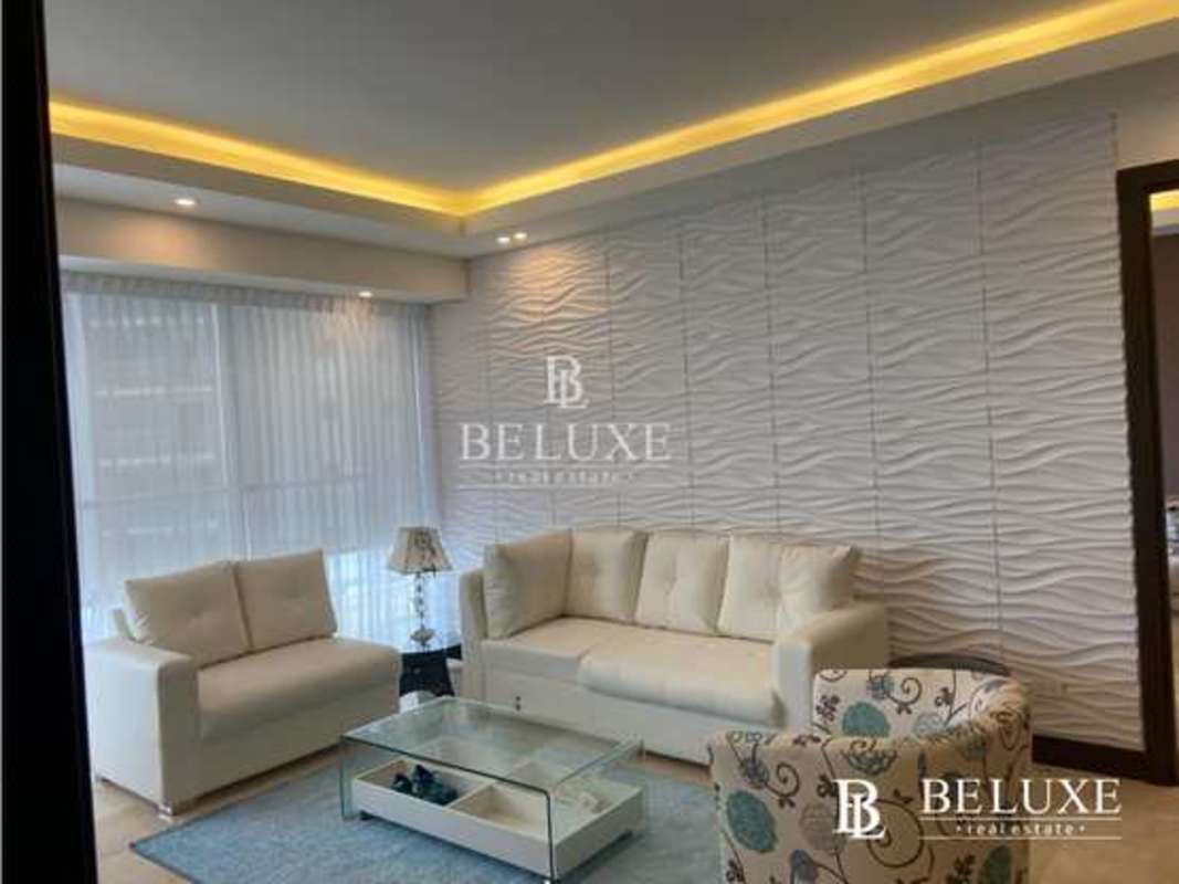 Bright furnished living room with large windows and skyline vistas in PH TOC Punta Pacifica Panama City