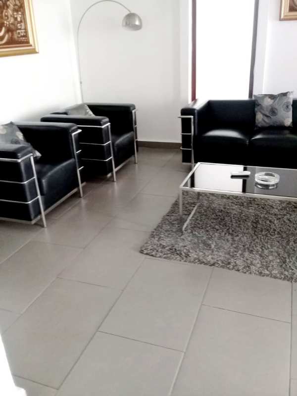 Spacious kitchen with granite countertops and wood cabinets in duplex house Obarrio Panama