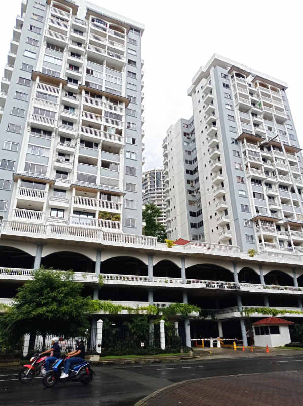 Mid-rise residential complex with balconies, arched ground floor, and gated entrance at La Cresta Panama City