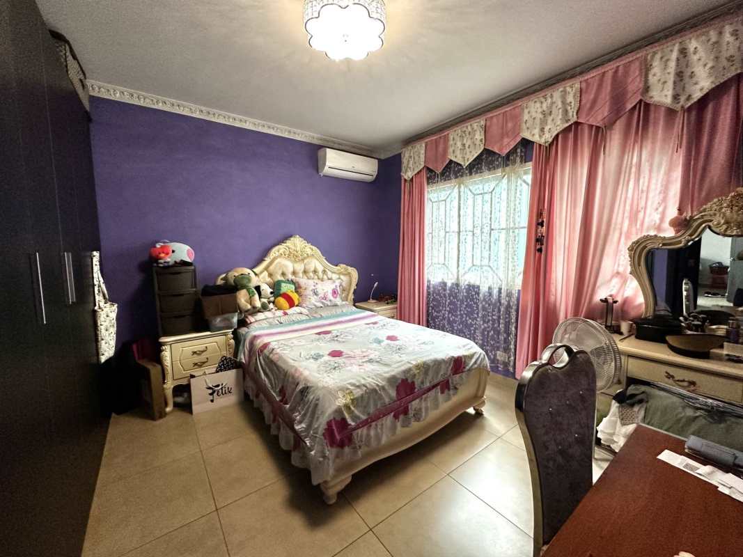 Bright bedroom with window, closet, AC unit in Dorado Village home Condado del Rey Panama