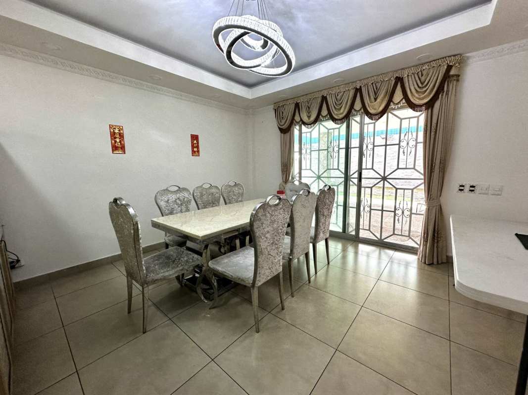 Kitchen with granite counters, island, appliances in Dorado Village home Panama City