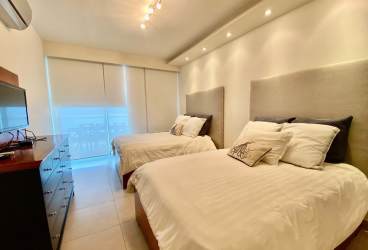 Minimalist bedroom large windows ocean view Santa Clara Residences Panama beachfront condo apartment for sale