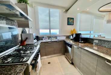 Aerial view beachfront condo tower infinity pool sun deck Santa Clara Residences Panama oceanfront property for sale