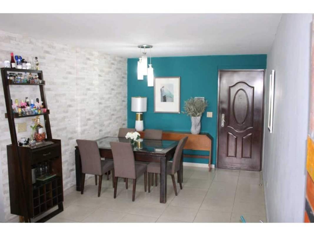 Dining room with glass table, accent wall, modern decor in PH Victory Tower