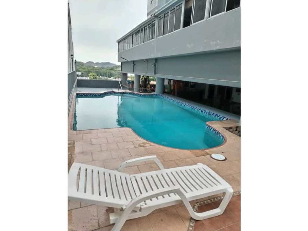 Covered rooftop swimming pool with lounge area and mountain views PH Victory Tower