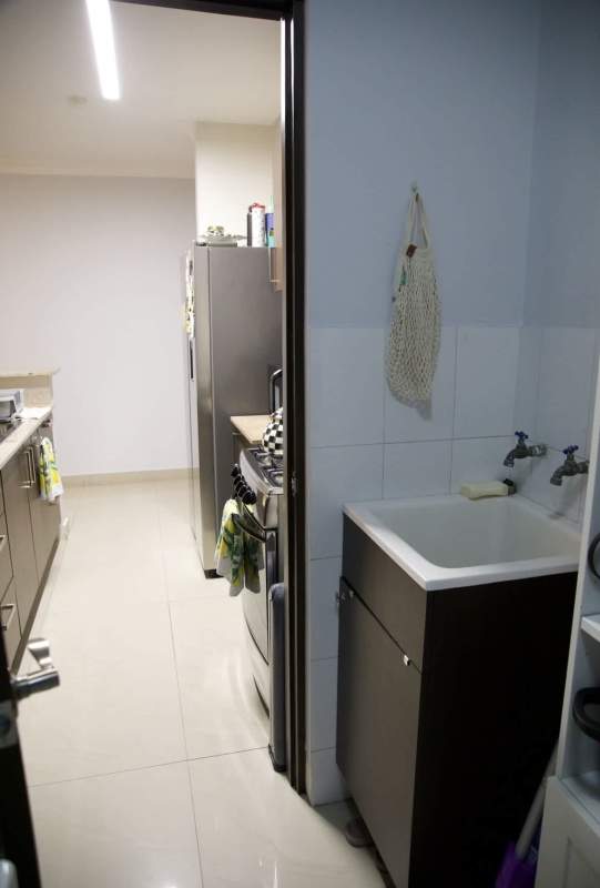 Modern living space with panoramic city views through large window PH Pacific Sun