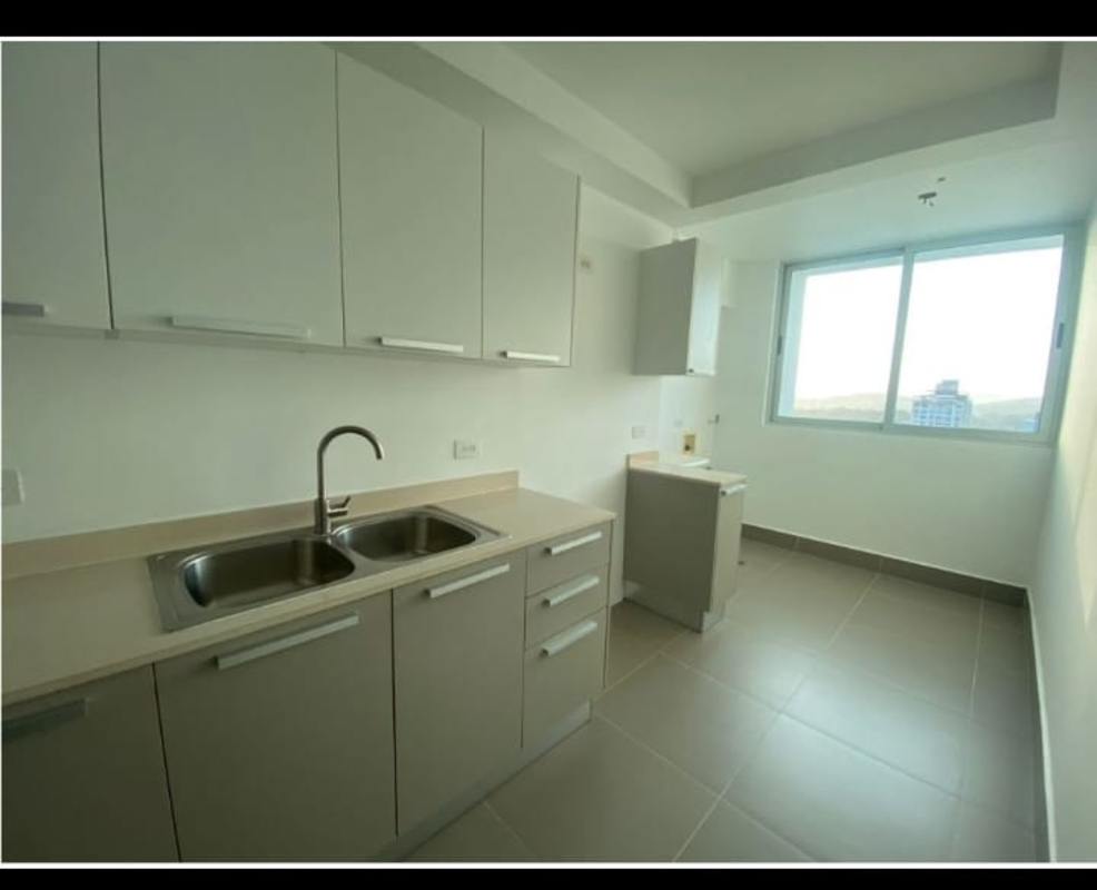 Modern open kitchen with large window, neutral cabinetry PH Altamira Panama City