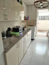 Covered outdoor patio with bar stools, ceiling fan, TV and green accents Sausalito Gardens Costa Verde Panama