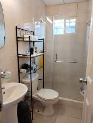Modern bathroom with glass shower, storage shelving and natural light rental house PH Sausalito Gardens Costa Verde Panama