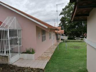 Living room with wood ceiling, tiled floors and sofa set in fully furnished Alta Boquete house for rent
