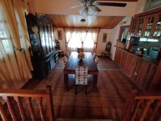 Dining room with wood-paneled ceiling, ceiling fan and tiled floor in Alto Boquete rental house