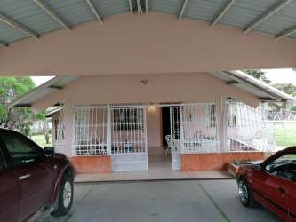Front facade with covered parking and garden of furnished rental home in Alto Boquete Panama