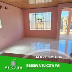 Living dining area with tiled floors, open kitchen counter and pink walls Villa Bonita Penonomé