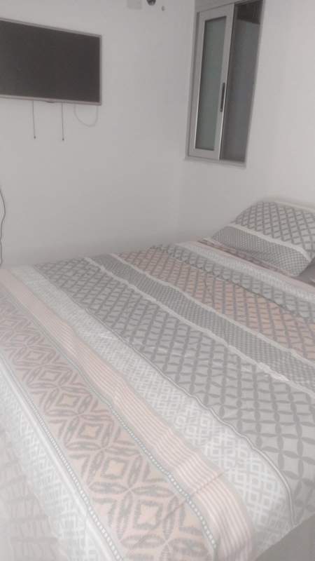 Modern shared kitchen with granite countertops, refrigerator, stove in Carrasquilla Panama