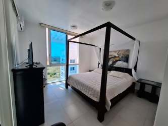 Aerial view of giant Playa Blanca saltwater pool and palm trees from penthouse terrace