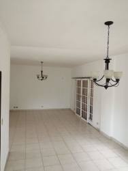 Large open space with chandeliers tile flooring and windows residential house in Panama Oeste