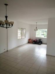 Interior staircase area with large window and iron railings two-story house Panama Oeste