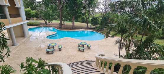 Outdoor swimming pool surrounded by lush gardens and elegant terraces in PH El Alcazar Coronado