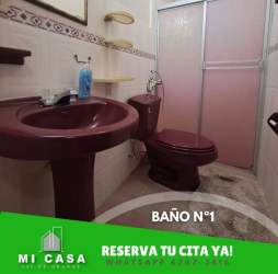 Traditional bathroom with shower enclosure sink and burgundy fixtures Penonomé rental house Panama