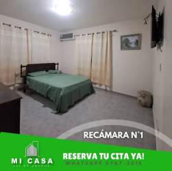 Kitchen with granite countertop stove refrigerator microwave overhead cabinets Coclé rental house