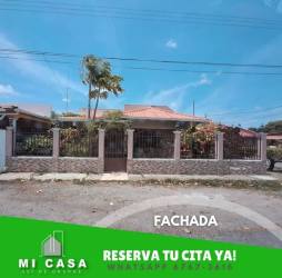 Living and dining room with sofa, TV, dining set, large window in rental house Penonomé Coclé