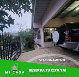 Exterior facade with stone fence metal gate and garden Penonomé rental house Coclé