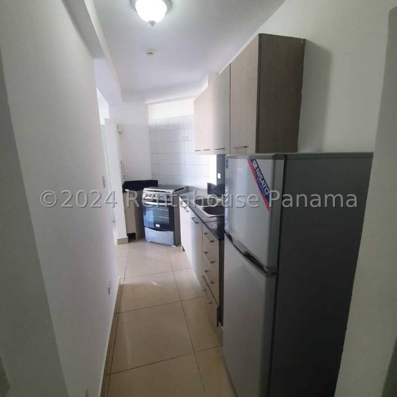 Galley kitchen with stove, refrigerator, cabinets PH Green Park apartment Panama City