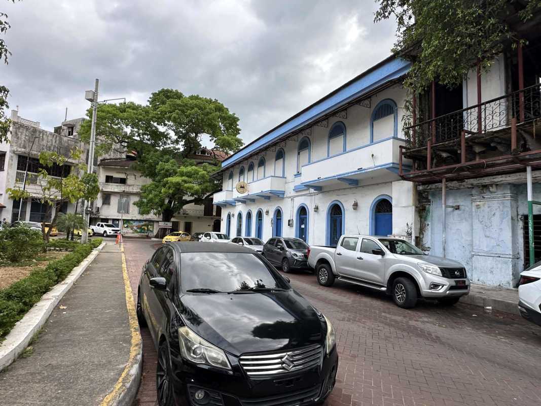 Panama City Casco Viejo two-story colonial building with balconies and street parking