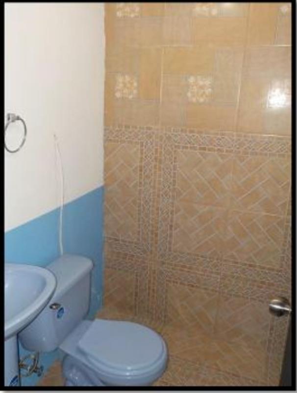 Bathroom with blue toilet and decorative tiles house in Altos de La Castellana Panama
